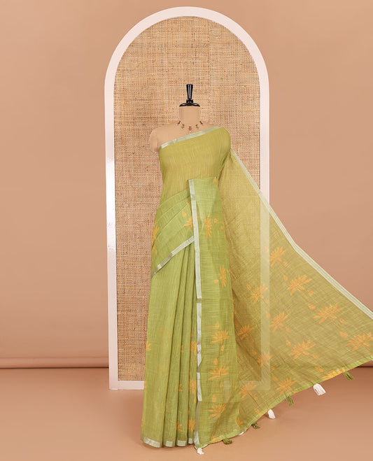 Green Pichwai lotus printed linen cotton saree, piping zari border, colorful tasselled lotus printed pallu, and a contrast lotus printed blouse