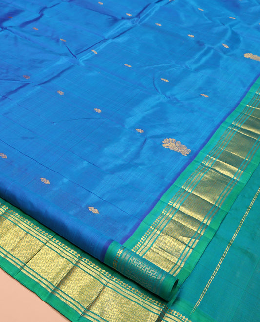 Blue Kanchipuram Silk Saree, Styled with Zari Buttas, Complemented by a Contrast One-Sided Border of Panner Sombu, Banaras, and Mayil Kann Designs, Grand Pallu, and No Blouse