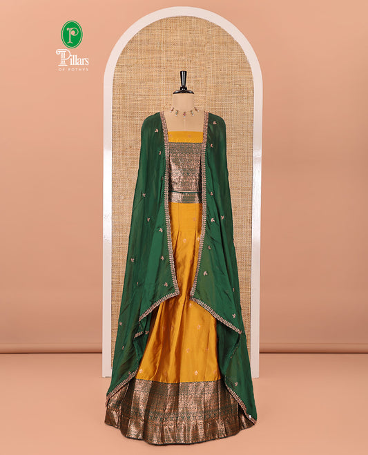 Yellow and Green Semi-Banarasi Half-Saree Beautifully Bedecked with Zari Buttas on Its Skirt, Complemented by a Contrast Traditional Zari Design Border, Paired with a Matching Blouse, and a Satin Georgette Embroidered Scallop Dhavani
