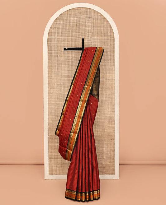 Orange Kanchipuram Silk Saree, Decked Up with Zari Buttas and Stripes All Over Its Body, Complemented by Contrast Rettai Pettu Border of Muthu, and Kathir Designs, Pallu of Jaal Designs, and Paired with a Contrast Blouse