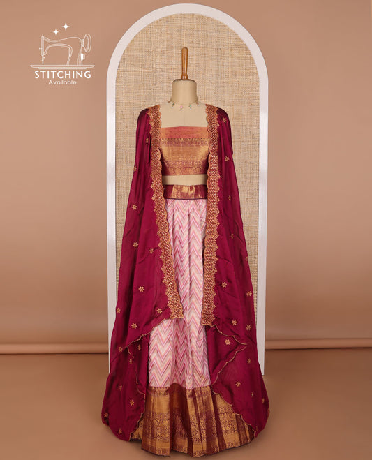 Light pink chevron design tissue half saree with contrast intricate zari design border, zari design blouse & scallop embroidery dhavani