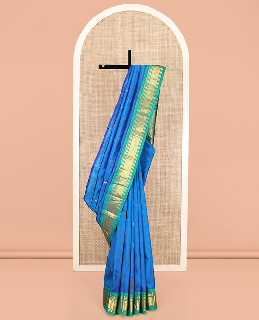 Blue Kanchipuram Silk Saree, Styled with Zari Buttas, Complemented by a Contrast One-Sided Border of Panner Sombu, Banaras, and Mayil Kann Designs, Grand Pallu, and No Blouse