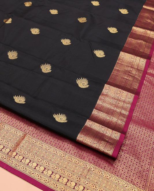 Black Vasundhara Lite Silk Mix Saree, Embellished with Zari Buttas on Its Body, Complemented by a Contrast Border of Thilakam Mokku,kodi Visiry, Muthu, Chakra, and Mayil Designs, Scallop Design Pallu, and Paired with a Contrast Blouse