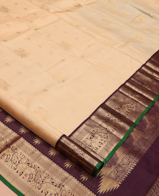 Sandal Vasundhara Silk Saree, Sparsely Woven with Zari Buttas All Over Its Body, Complemented by Contrast Border of Mayil Kann and Yaanai Designs, Grandly Decked Up Pallu and Paired with a Contrast Blouse