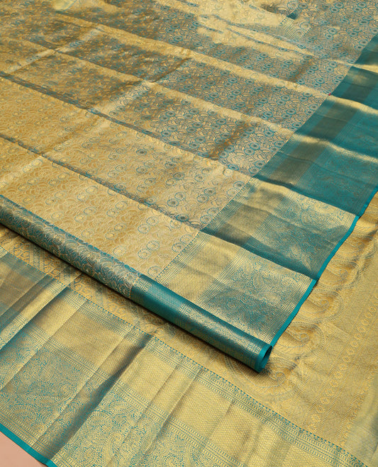 Blue Kanchipuram Silk Saree, Elegantly Highlighted with Zari Jacquard Design All Over Its Body, Highlighted by a Zari Border of Thilakam Mokku, Muthu, Mayil Kann, and Manga Designs, and Pallu of Mughal-Style Designs, and Paired with a Matching Blouse