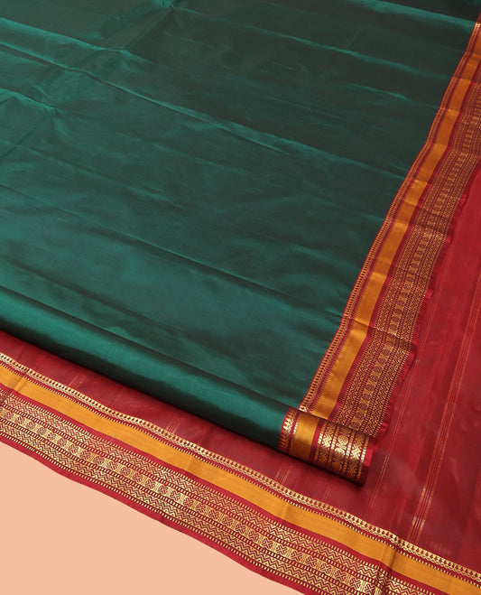 Green Plain Kanchipuram Silk Saree, Complemented by a Contrast Border of Rekku, Muthu, Rettai Neli, and Rudraksham Designs, Zari-Woven Pallu, and Paired with a Contrast Blouse