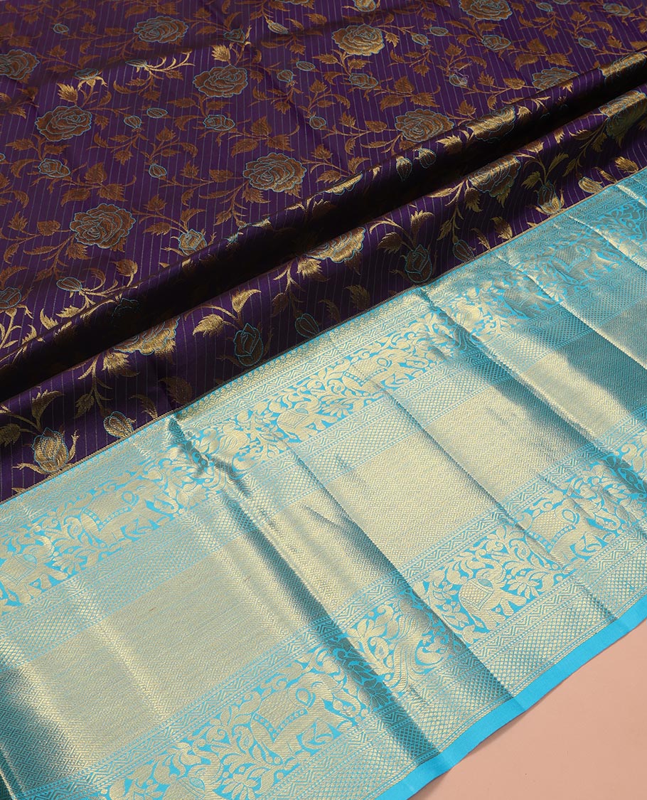 Violet Pure Silk Half-Saree, Gracefully Embellished with Floral Jacquard All Over Its Skirt, Complemented by a Contrast Border of Mayil, Yaanai, Mayil Kann, and Jaal Designs, Paired with a Contrast Blouse, and Comes with a Zari Design Dhavani