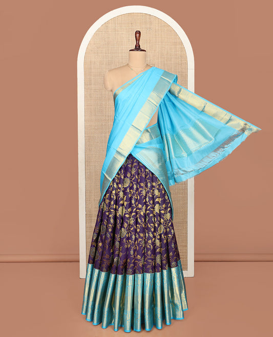 Violet Pure Silk Half-Saree, Gracefully Embellished with Floral Jacquard All Over Its Skirt, Complemented by a Contrast Border of Mayil, Yaanai, Mayil Kann, and Jaal Designs, Paired with a Contrast Blouse, and Comes with a Zari Design Dhavani