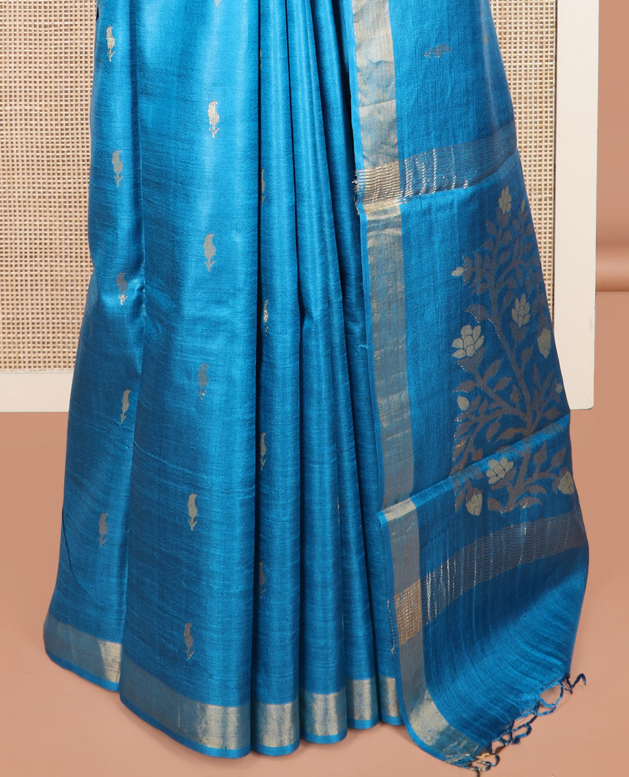 Blue paisley buttas tussar saree, zari border, and pallu of floral designs