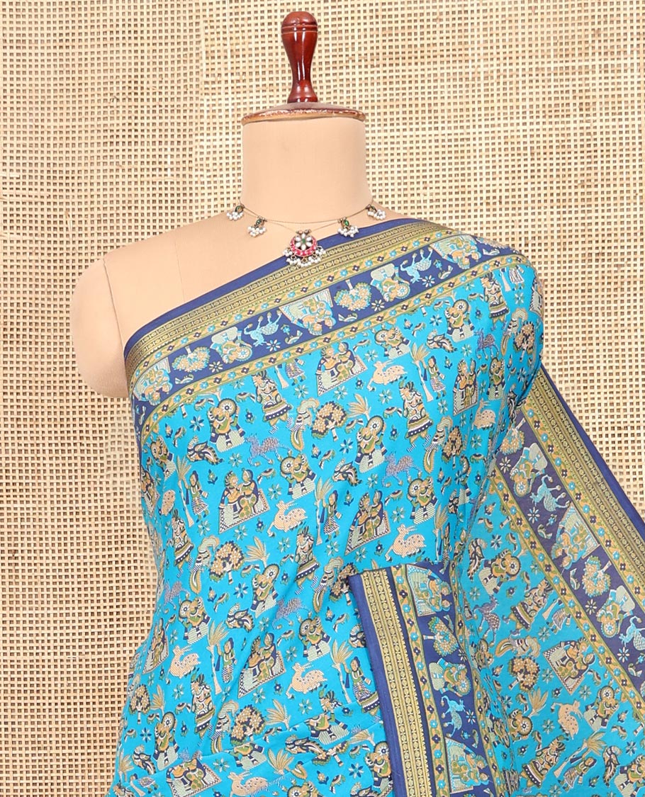 Blue Printed Silk Saree, Adorned with a Village-Themed Print, a Contrast Traditional Zari Border, Striped Pallu, and a Contrast Blouse