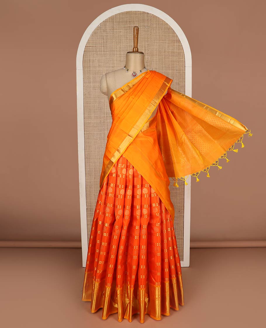 Orange pure-silk half-saree, zari buttas and checked skirt, contrast kodi visiry border, zari design blouse, and a intricate zari woven dhavani