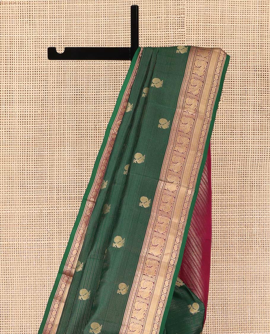 Green Kanchipuram Silk Saree, Beautified with Mayil Buttas and Zari Stripes on Its Body, Complemented by Contrast Border of Muthu, Diamond, Mayil, and Laddu Kamalam Designs, Diagonally Striped Pallu, and Paired with a Contrast Blouse