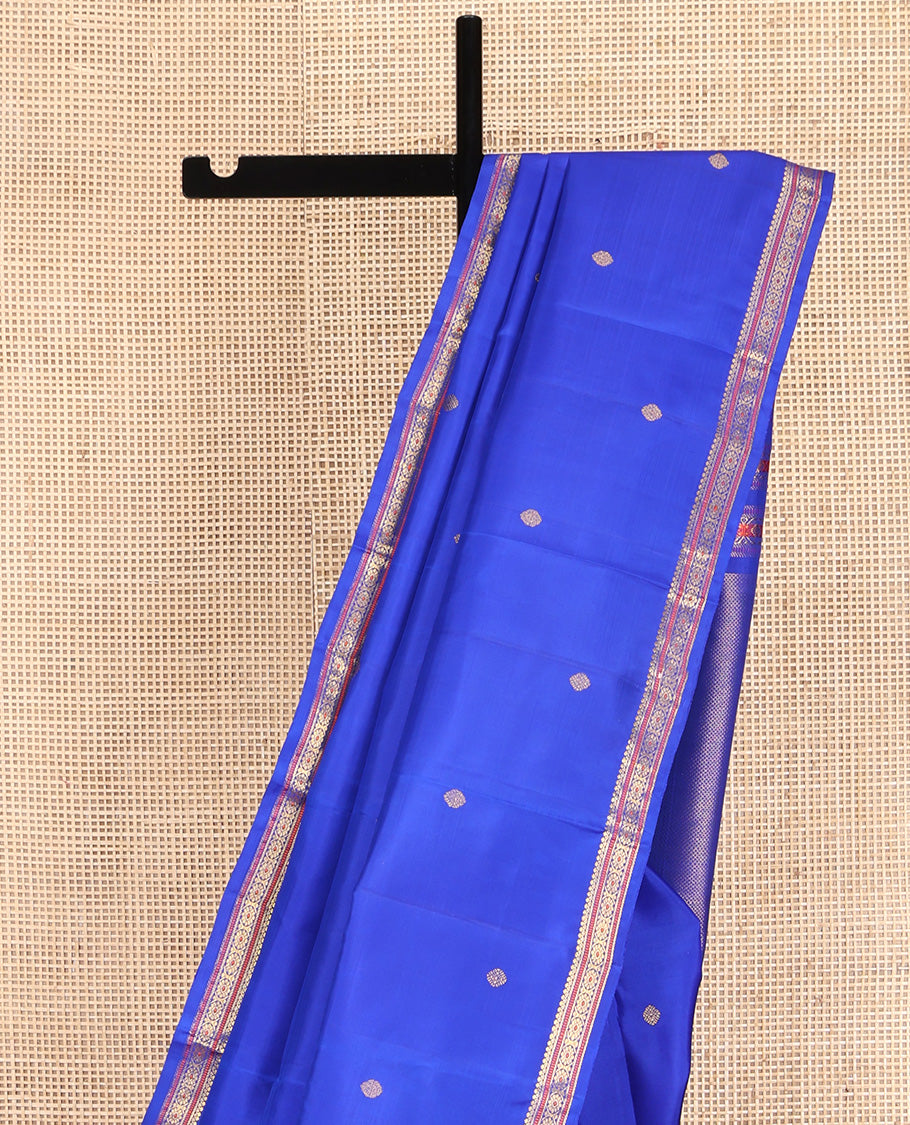 Royal Blue Kanchipuram Silk Saree, Elevated with Zari Buttas All Over Its Body, Highlighted by Zari Border of Salngai, Muthu, and Chakram Designs, Pallu of Mayil Kann Design, and Paired with a Matching Blouse