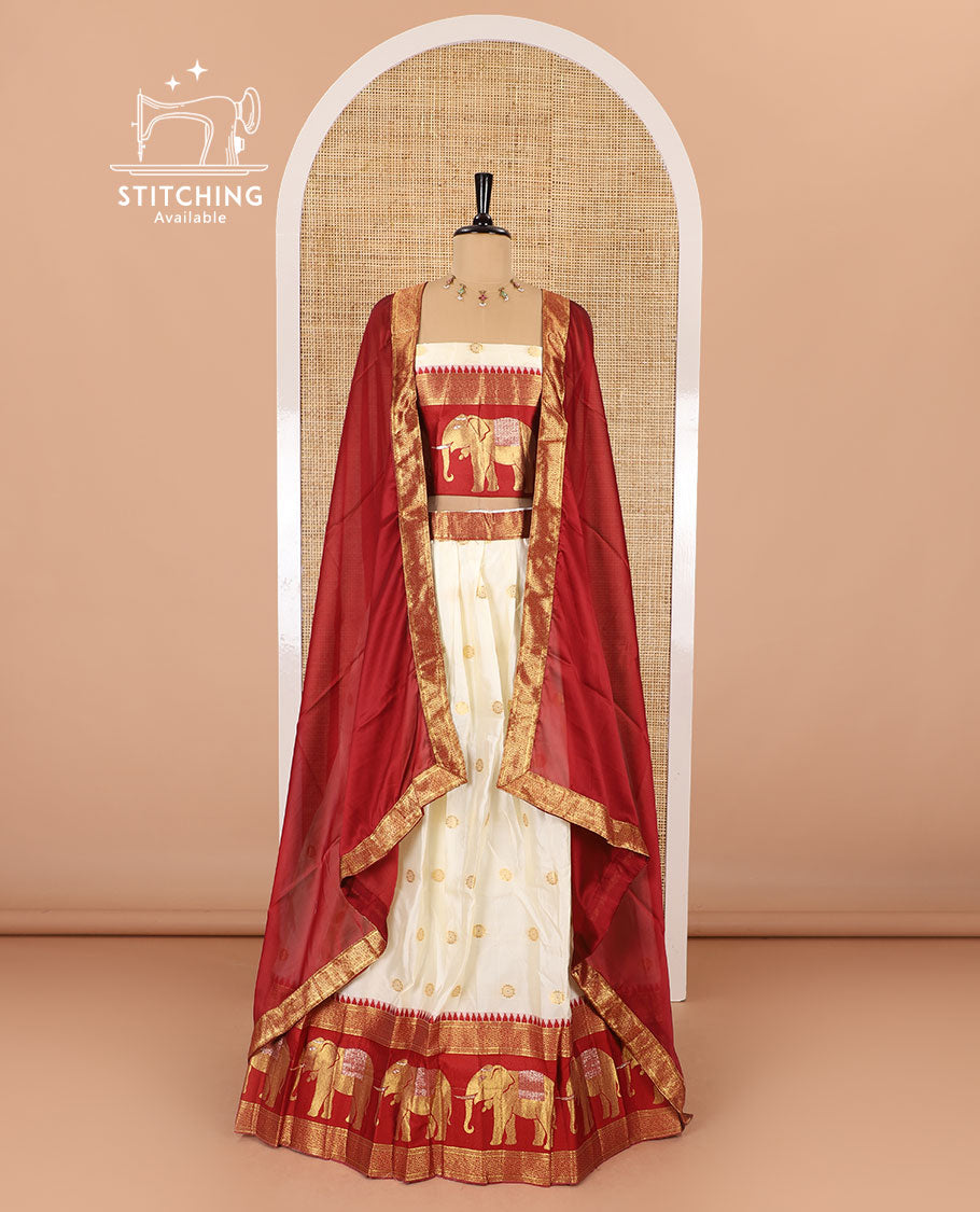 Cream-crimson half-saree, zari buttas with contrast traditional zari elephant motifs bordered skirt, matching blouse and a contrast zari border dhavani