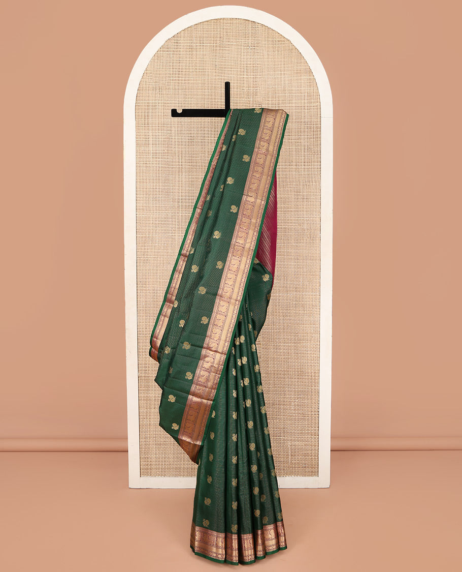 Green Kanchipuram Silk Saree, Beautified with Mayil Buttas and Zari Stripes on Its Body, Complemented by Contrast Border of Muthu, Diamond, Mayil, and Laddu Kamalam Designs, Diagonally Striped Pallu, and Paired with a Contrast Blouse