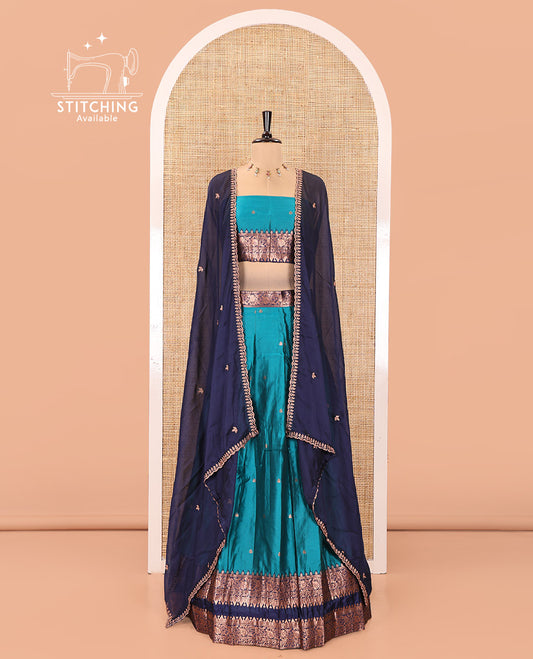 Rama Green and Blue Semi-Banarasi Half-Saree, Accentuated with Zari Buttas on Its Skirt, Complemented by a Contrast Rettai Pettu Traditional Zari-Design Border, Paired with a Matching Blouse, and Comes with a Contrast Satin Georgette Embroidered Dhavani