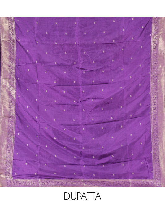 Purple Semi-Silk Material Churidar Features Zari Buttas Woven Top, a Santoon Bottom, and Zari Design Dupatta