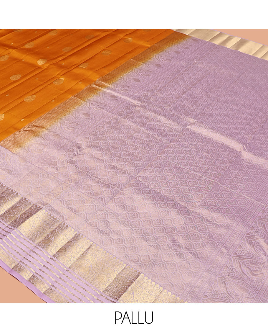 Orange Vasundhara Silk Saree, Decked Up with Zari Buttas All Over Its Body, Complemented by a Contrast Border of Yaanai, Thilakam, Neli, Kamalam, Mayil, and Manga Designs, Grand Jaal Pallu, and Paired with a Contrast Blouse