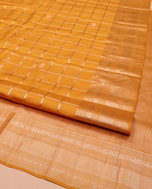 Yellow Vasundhara Silk Saree, Enriched with Zari Butta Enclosed Checked Design All Over Its Body, Highlighted by Zari Border of Thilakam Mokku, Muthu, Mayil, Yaanai, and Mayil Kann Designs, Grand Jaal Pallu, and Paired with a Matching Blouse