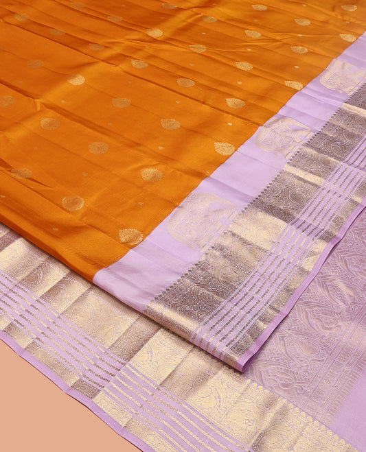 Orange Vasundhara Silk Saree, Decked Up with Zari Buttas All Over Its Body, Complemented by a Contrast Border of Yaanai, Thilakam, Neli, Kamalam, Mayil, and Manga Designs, Grand Jaal Pallu, and Paired with a Contrast Blouse