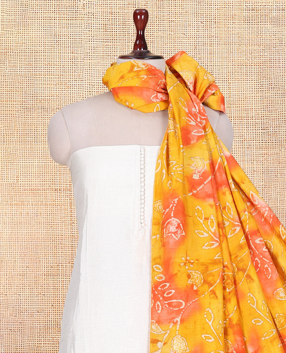 Cream-Orange Kerala Cream Mul Chanderi Material Churidar Features Pom-Pom Neckline Top, a Contrast Batik Floral Printed Bottom, and  Dupatta