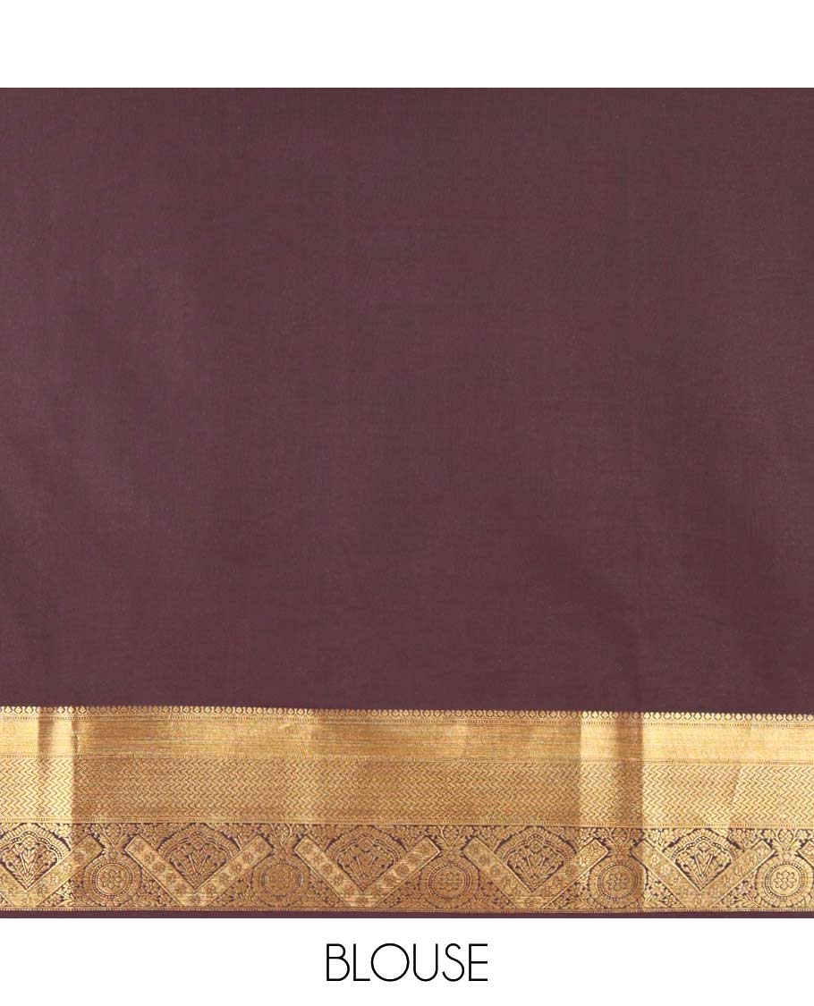 Brown Kanchipuram budget silk saree enriched with zari butta enclosed checks all over its body, complemented by zari traditional design border, Mughal-style intricate pallu, and paired with a Matching blouse