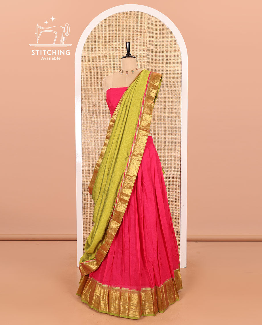 Rani Pink and Parrot Green Chettinad Cotton Half-Saree Featuring a Plain Skirt, Highlighted with a Contrast Floral-Peacock Zari Border, a Subtly Woven Matching Blouse, and a Vichitra Silk Contrast Traditional Zari Bordered Dhavani