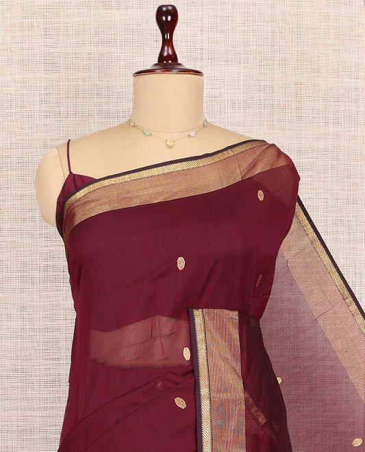 Maroon Maheshwari Cotton Saree, Bedecked with Buttas, Highlighted by a Traditional Zari Border, Zari Gleamed Up Pallu, and a Matching Blouse