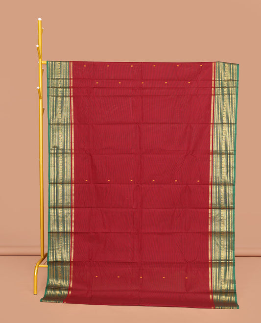 Maroon Chettinad Cotton Saree, Adorned with Buttas All Over Its Body, Complemented by Contrast Traditional Zari Design Border, Pallu of Stripes and Buttas, and Paired with a Matching Blouse