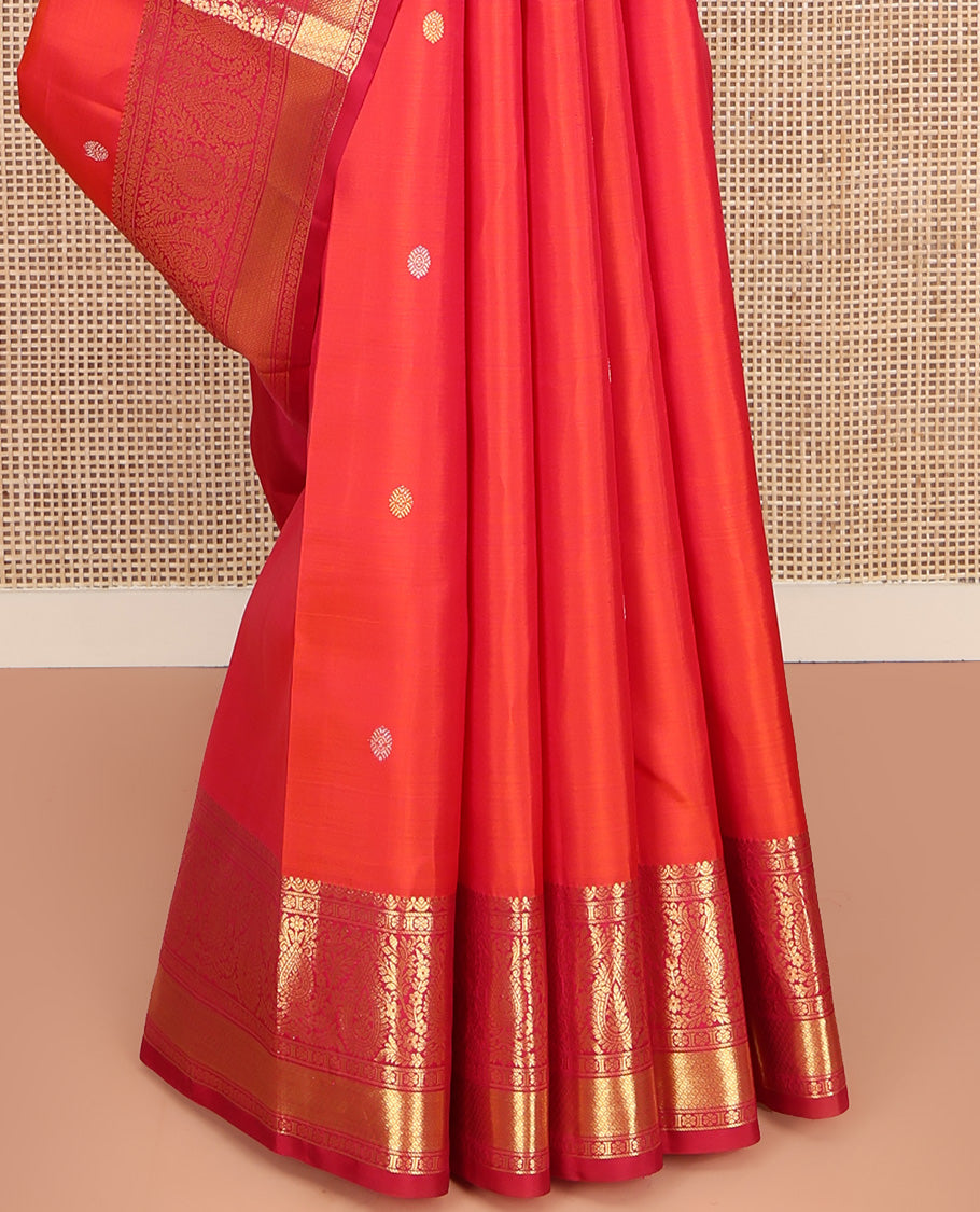 Orange Kanchipuram Silk Saree, Adorned with Zari Buttas All Over Its Body, Complemented by Contrast Border of Kamalam, Thilakam, and Mayil Kann Designs, Grand Jaal Pallu, and Paired with a Contrast Blouse