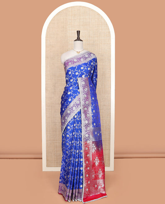 Ultramarine blue floral jaal jacquard banarasi silk saree, contrast lace zari border of floral creeper designs, and pallu of Mughal-style intricate motifs