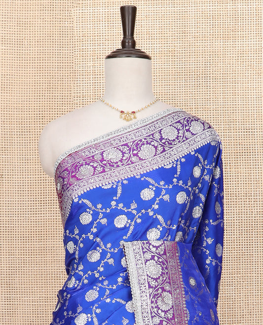 Ultramarine blue floral jaal jacquard banarasi silk saree, contrast lace zari border of floral creeper designs, and pallu of Mughal-style intricate motifs