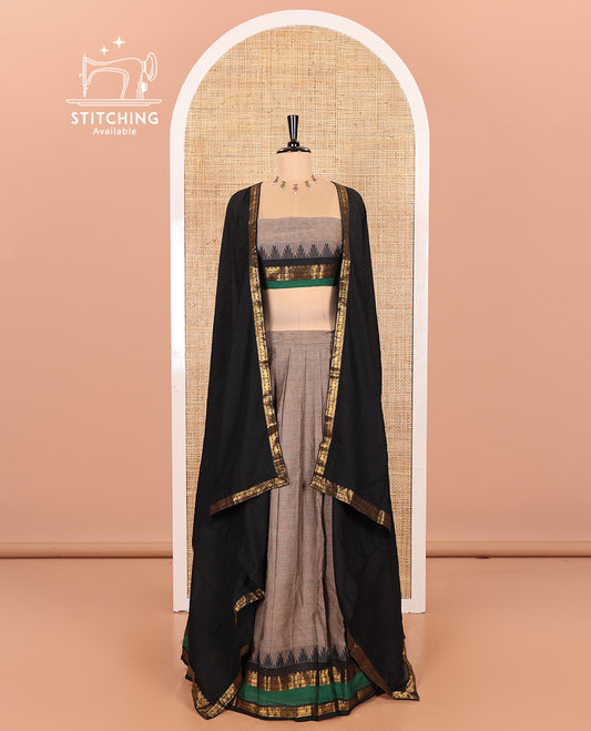 Steel Grey-Black Chettinad Cotton Half-Saree Featuring a Plain Skirt, Highlighted with a Contrast Traditional Zari Rettai Pettu Temple Border, a Subtly Woven Matching Blouse, and a Vichitra Silk Contrast Traditional Zari-Bordered Dhavani