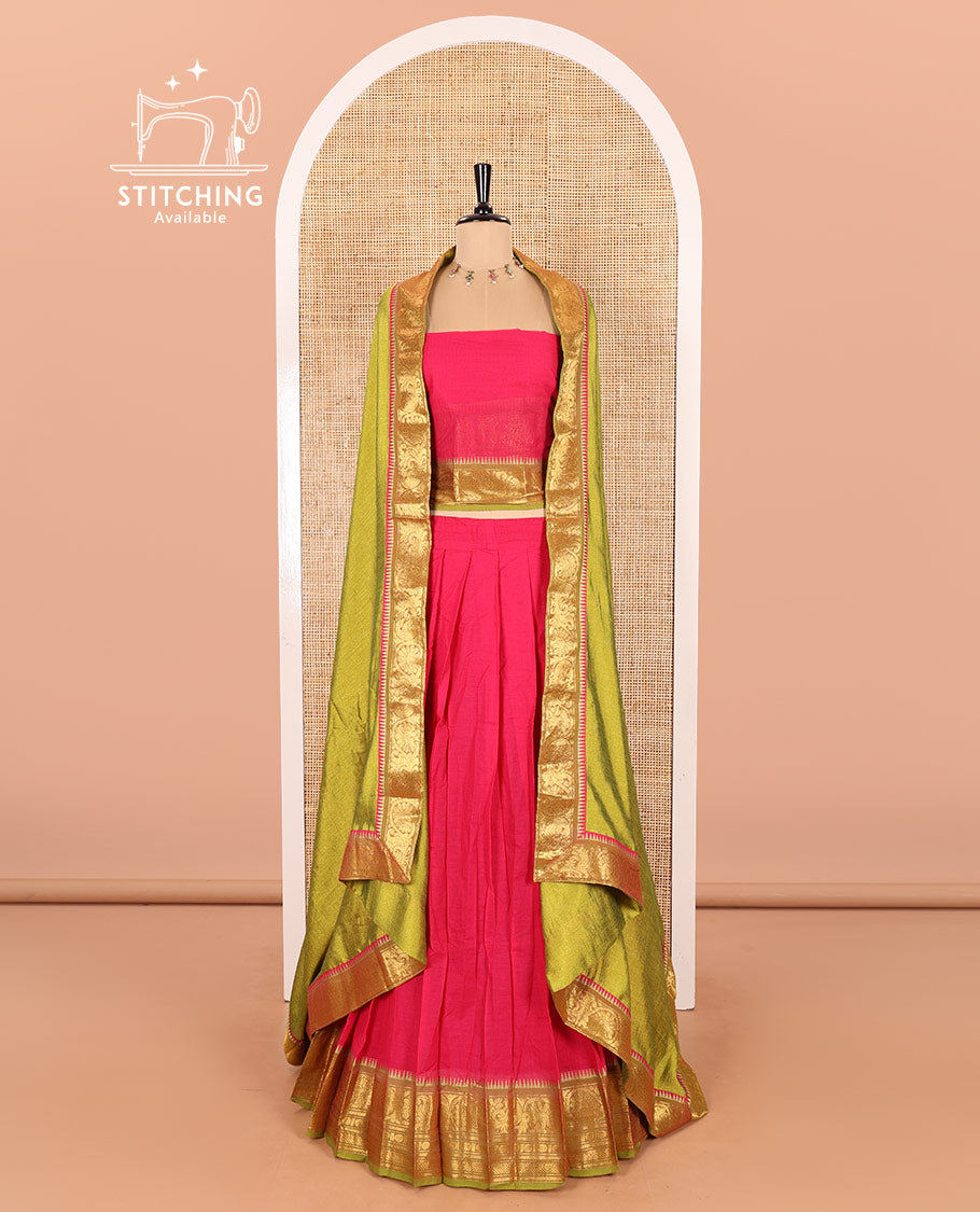 Rani Pink and Parrot Green Chettinad Cotton Half-Saree Featuring a Plain Skirt, Highlighted with a Contrast Floral-Peacock Zari Border, a Subtly Woven Matching Blouse, and a Vichitra Silk Contrast Traditional Zari Bordered Dhavani