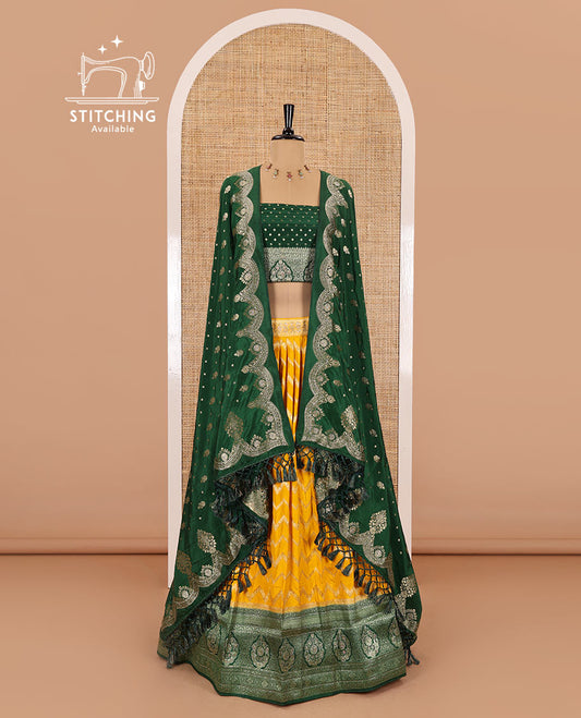 Haldi yellow chiniya crepe half-saree, chevron zari jacquard with contrast intricate patterned stone work bordered skirt, contrast blouse, and a scallop bordered intricate dhavani