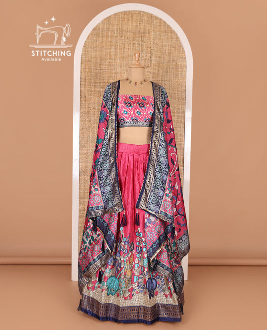 Pink semi-tussar half-saree, kalamkari human figurines printed with a contrast geometric bordered skirt, patola printed blouse, and kalamkari floral vine printed dhavani