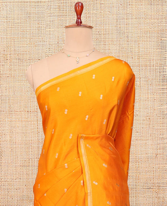 Orange Satin Silk Saree, Subtly Sparkled with Buttas All Over Its Body, a Subtle Piping Border, Complemented by a Contrast Pallu of Floral-Paisley Designs in Zari, and Paired with a Contrast Blouse