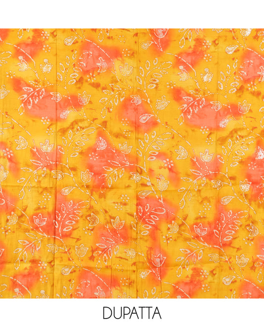 Cream-Orange Kerala Cream Mul Chanderi Material Churidar Features Pom-Pom Neckline Top, a Contrast Batik Floral Printed Bottom, and  Dupatta