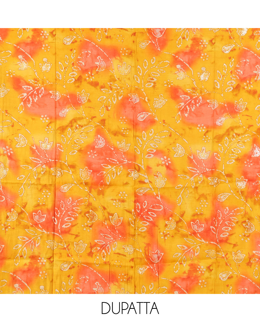Cream-Orange Kerala Cream Mul Chanderi Material Churidar Features Pom-Pom Neckline Top, a Contrast Batik Floral Printed Bottom, and  Dupatta