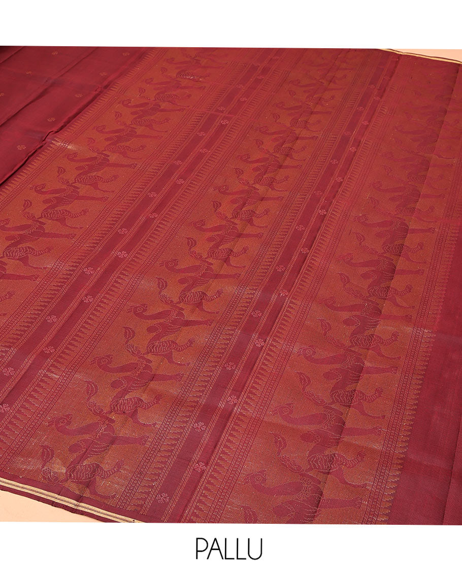 Maroon Mayuri Soft Silk Saree, Adorned with Zari Buttas All Over Its Body, Highlighted by Zari Border of Navagunjara Motifs, Pallu Steeped with Navagunjara Designs, and Paired with a Matching Blouse