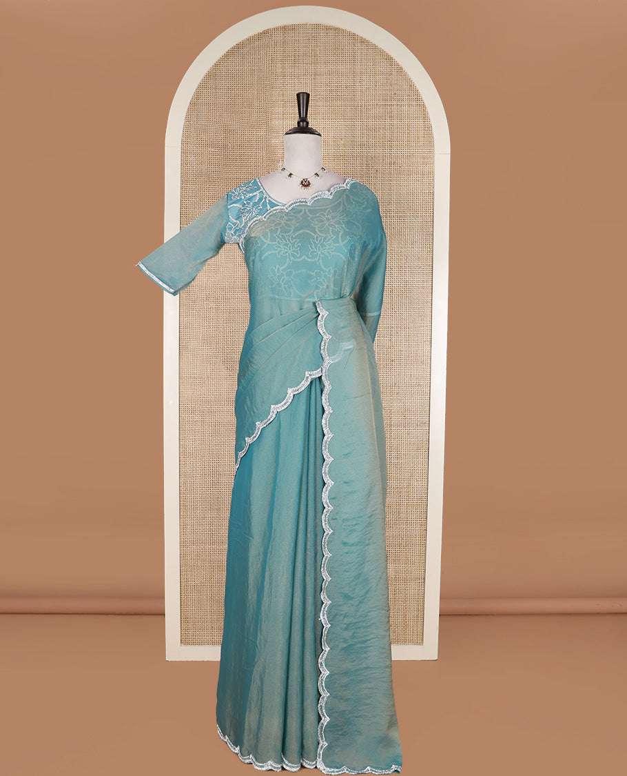 Blue plain designer saree, scallop embroidered border, and a matching elbow sleeve blouse of floral vine in micro-stones