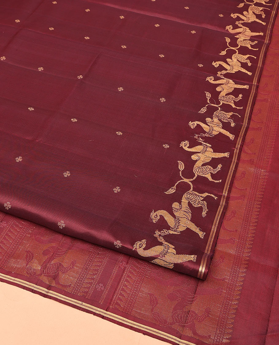 Maroon Mayuri Soft Silk Saree, Adorned with Zari Buttas All Over Its Body, Highlighted by Zari Border of Navagunjara Motifs, Pallu Steeped with Navagunjara Designs, and Paired with a Matching Blouse