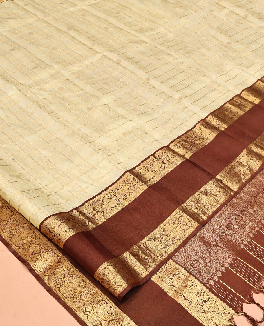 Pale Green Vasundhara Silk Saree, Enriched with Zari Buttas Enclosed Checks All Over Its Body, Complemented by a Contrast Rettai Pettu Border of Muthu, Banaras, and Iruthalai Pakshi Designs, a Grand Pallu, and Paired with a Contrast Blouse