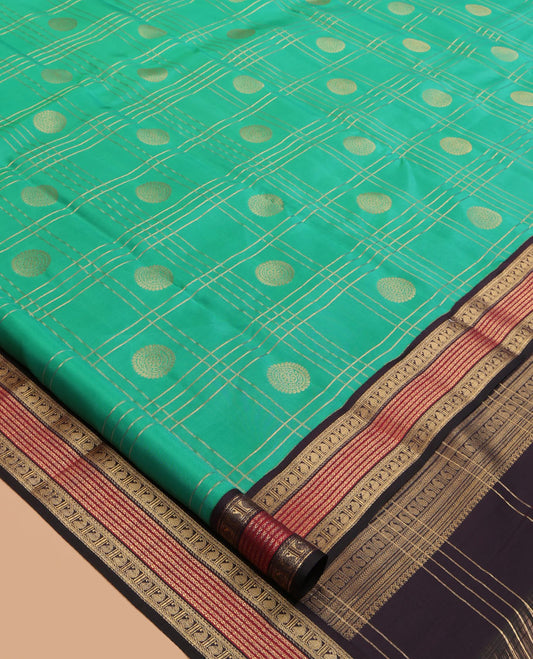 Green Vasundhara Lite Silk Mix Saree Features Butta Enclosed Checks, a Contrast Manga Design Border, Mayil-Chakram Pallu, and Contrast Blouse