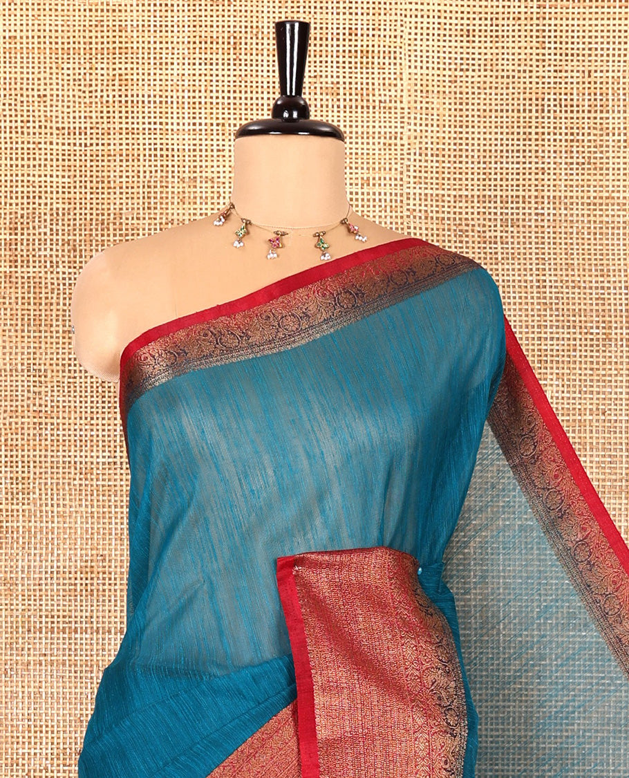 Rama blue plain linen saree, contrast traditional zari design border, striped pallu, and a contrast embroidered blouse