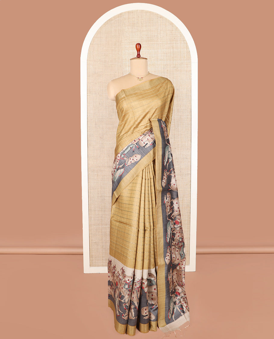 Gold horizontal striped tussar silk saree, Pichwai cow motifs printed border, and striped pallu