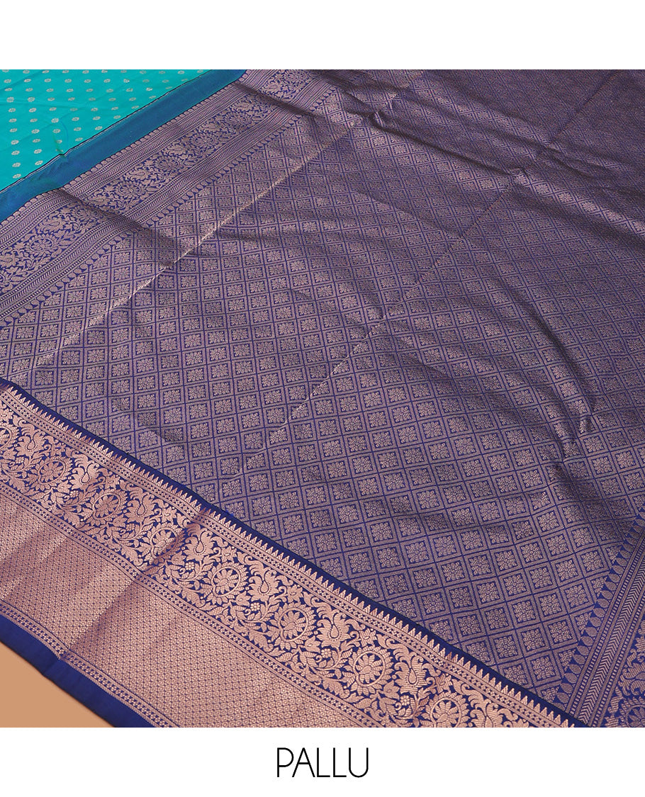 Blue zari buttas Vasundhara silk saree, contrast border of rekku, kodi visiry, and jaal designs, and zari-rich jaal pallu