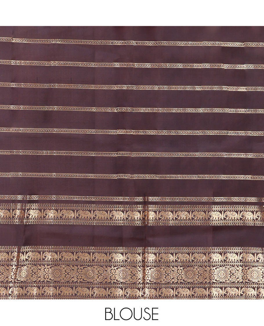 Brown Vasundhara Silk Saree, Enriched with Annam Chakram Buttas and Zari Stripes, Highlighted by Zari Rettai Pettu Border of Ara Bogudi, Muthu, Banaras, Yaanai, and Chakram Designs, Gleaming Jaal Design Woven Pallu, and Paired with a Matching Blouse