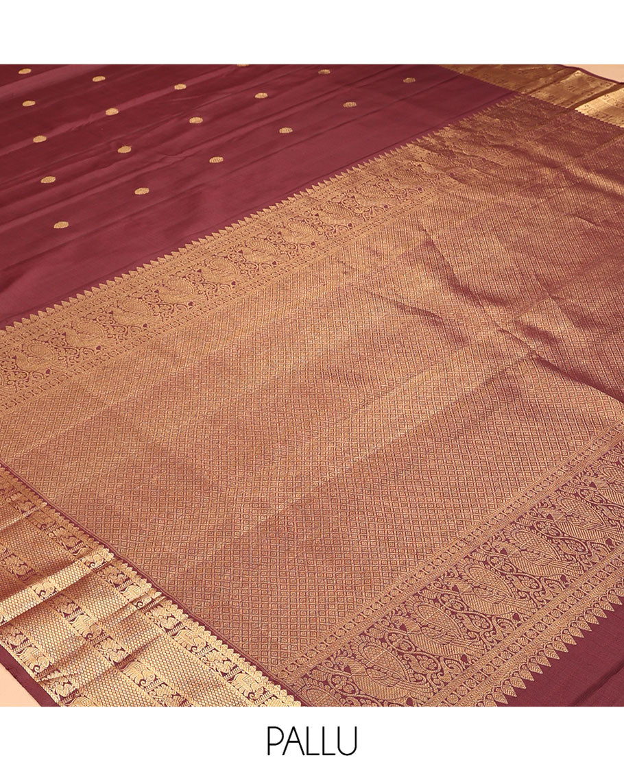 Brown Kanchipuram Silk Saree, Adorned with Zari Buttas, a Zari Border of Iruthalai Pakshi, Thilakam, Kathir, Mayil, Yaanai, and Mayil Kann Designs, Jaal Pallu, and a Matching Blouse