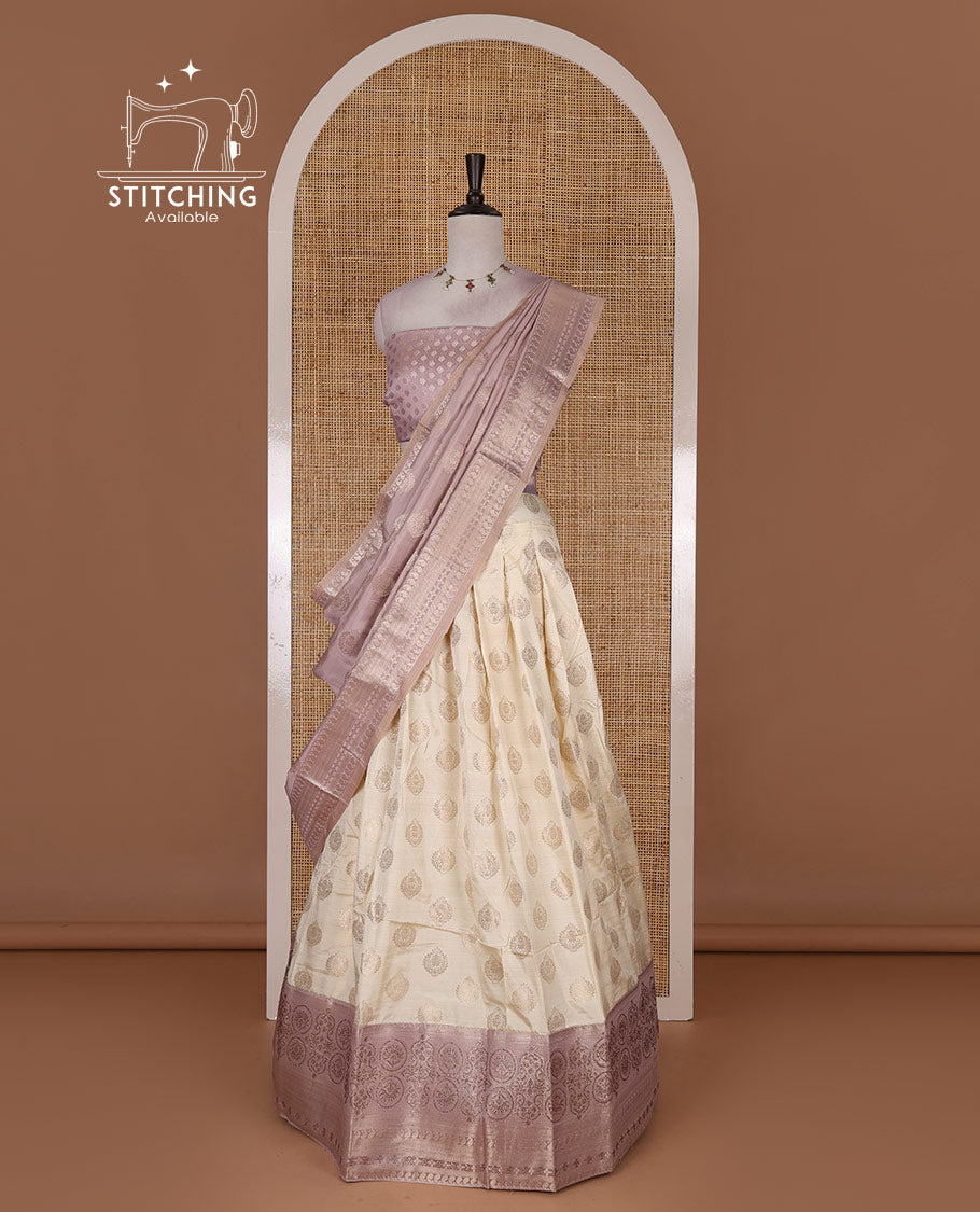 Cream and lavender semi-banarasi half-saree, zari buttas with contrast swarovski stone work border skirt, contrast zari buttas blouse, and intricate zari dhavani